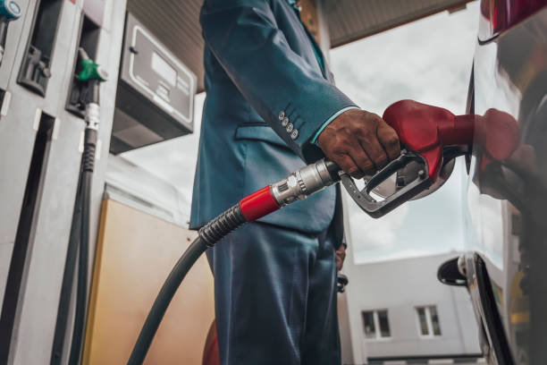 Young man refuelling his modern car at a petrol station